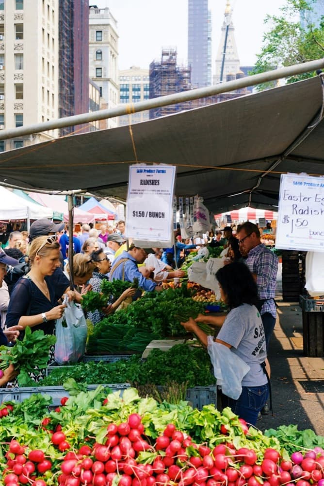 Locals shopping at an outdoor produce market